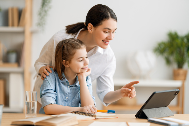 Girl doing homework or online education. devices for students learning at home