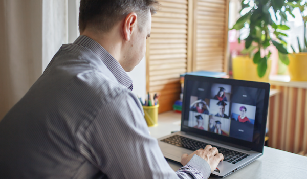 Photo of a man on a Zoom call with graduates