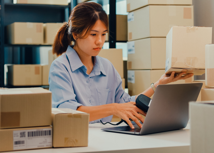 photo of women packing boxes and using orders and inventory management software on Salesforce