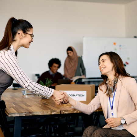 Photos of non-profit women shaking hands